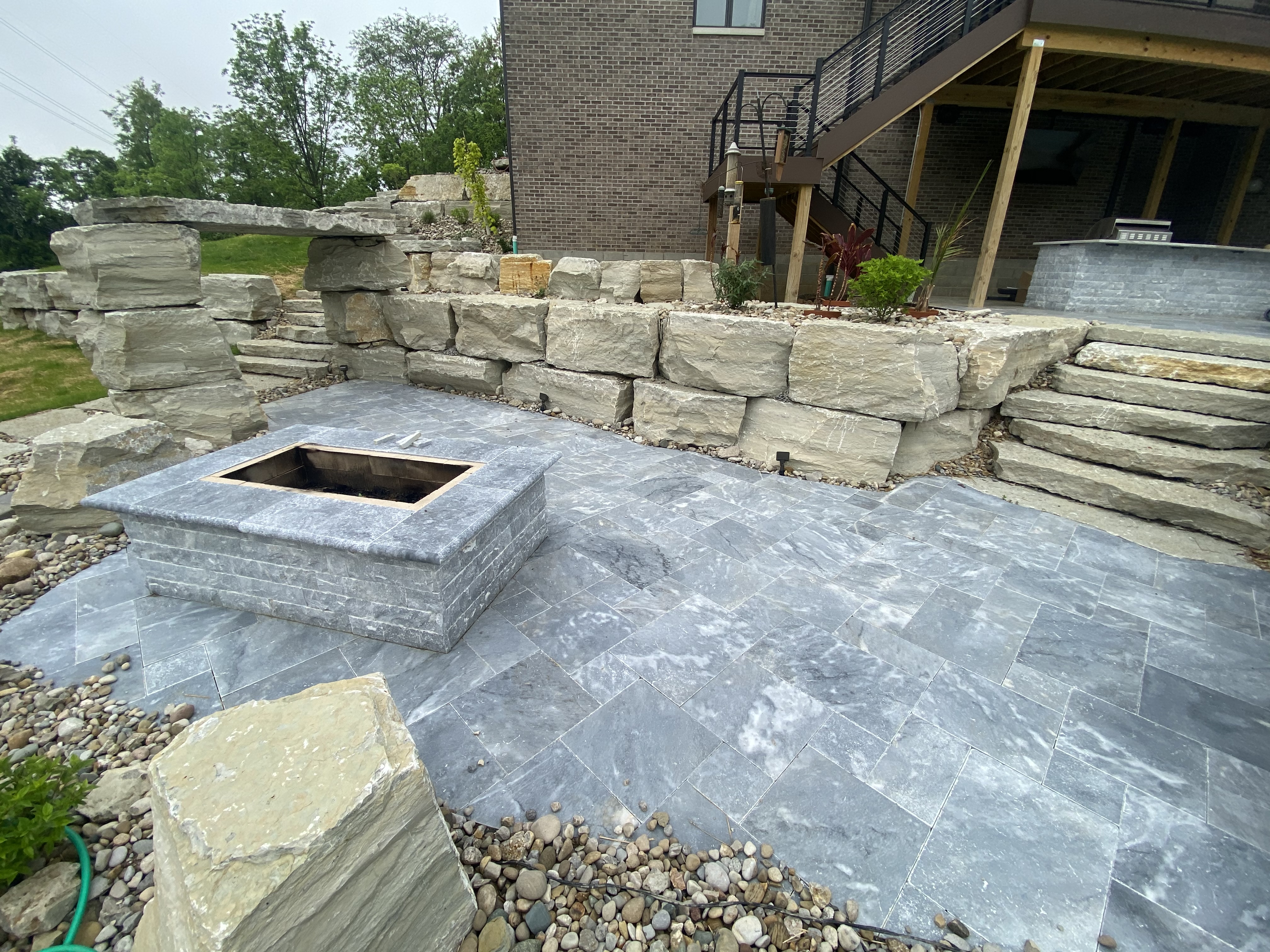 Retaining wall with patio by Oak Roots LLC Milan Indiana